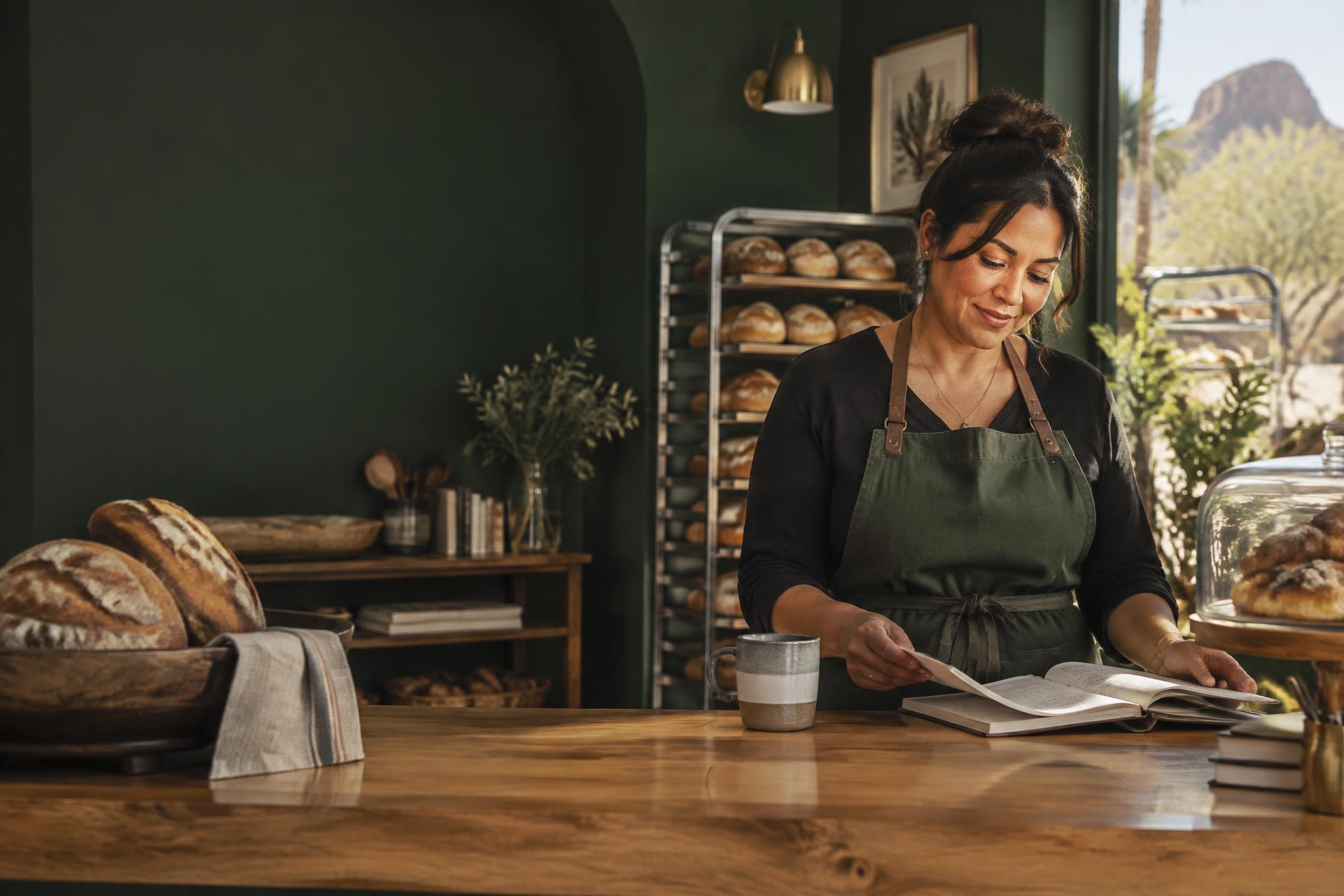 A local bakery owner reviewing her business records